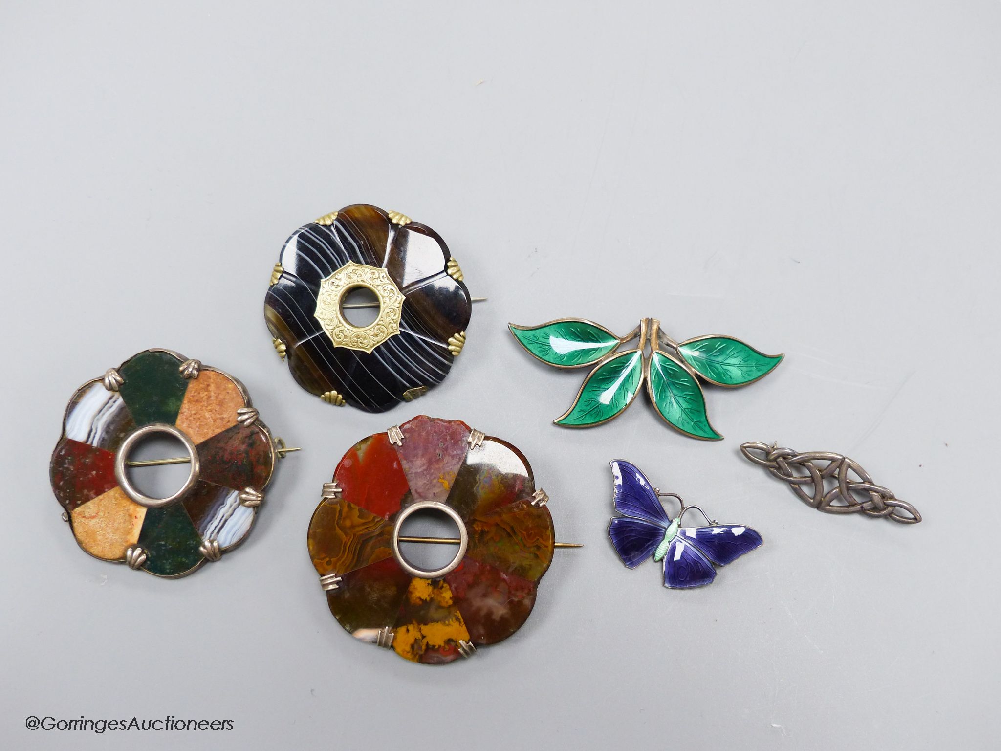 Two sterling and enamel brooches, including butterfly, 37mm, one other white metal brooch and three hardstone set brooches.